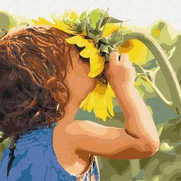 Child near a sunflower