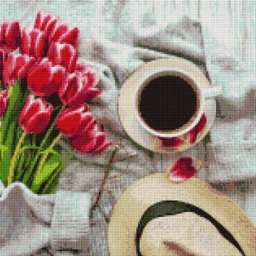Cup of coffee and pink tulips